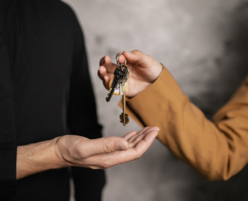 Someone giving another person a set of house keys