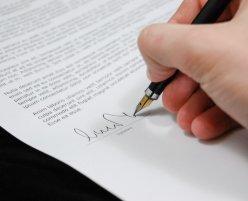 Someone signing a document